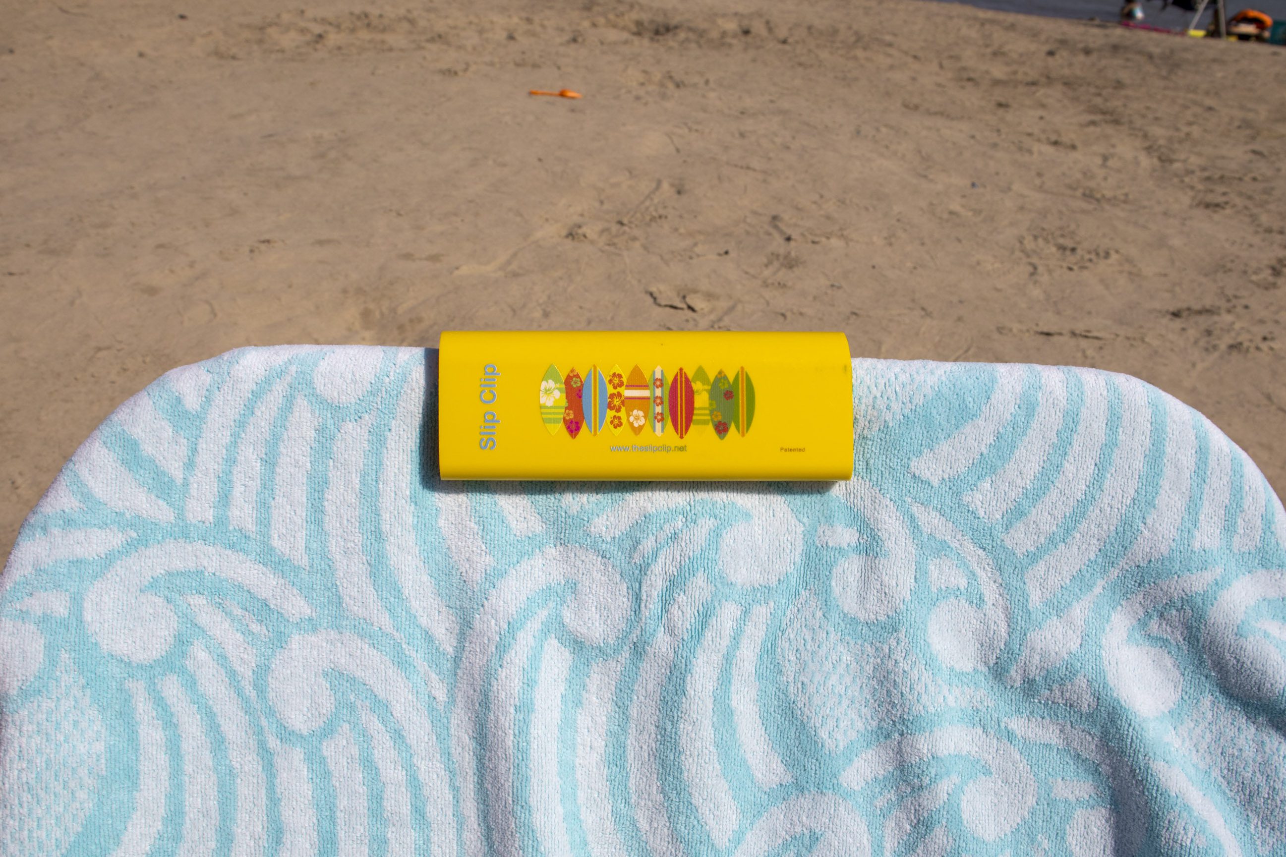Sunscreen on patterned towel at beach